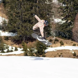Snowboarder grabbing mid-air over spring snow in the Arlberg